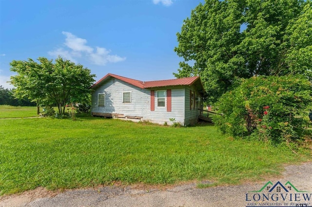 view of side of property with a lawn