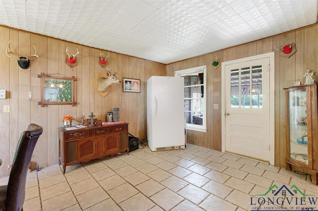 interior space featuring wooden walls and light tile patterned flooring