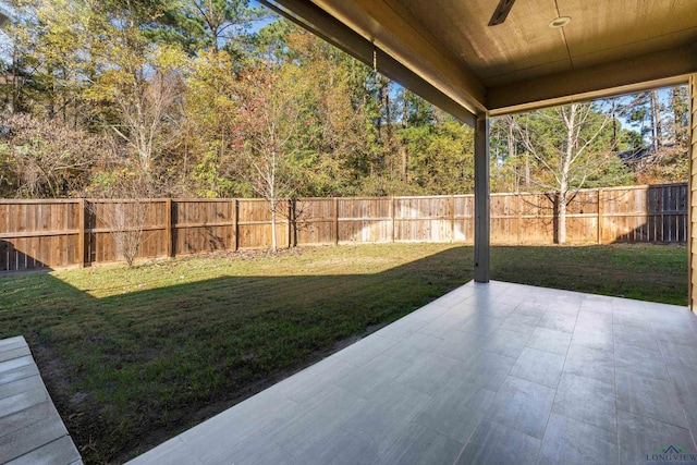 view of yard featuring ceiling fan and a patio area