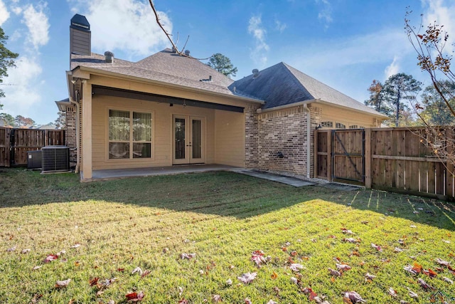 back of property featuring a patio area, central AC, a yard, and french doors