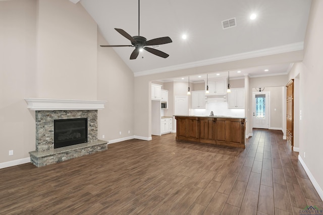 unfurnished living room with ceiling fan, a fireplace, high vaulted ceiling, and dark hardwood / wood-style floors