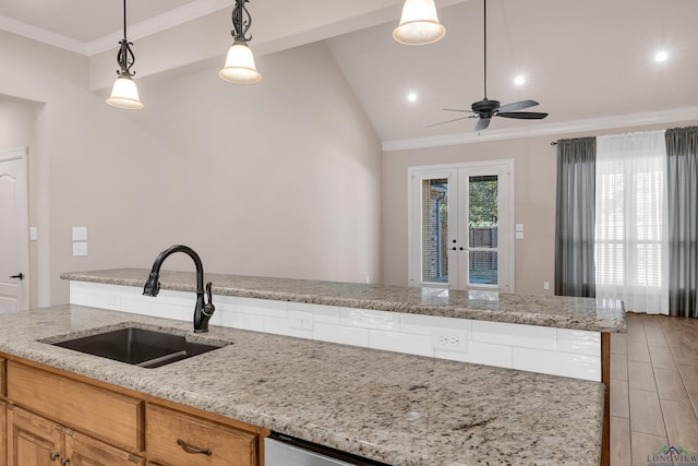 kitchen featuring ceiling fan, sink, french doors, light stone counters, and pendant lighting