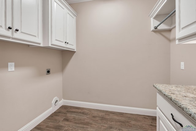 laundry area featuring hookup for an electric dryer, cabinets, and dark wood-type flooring