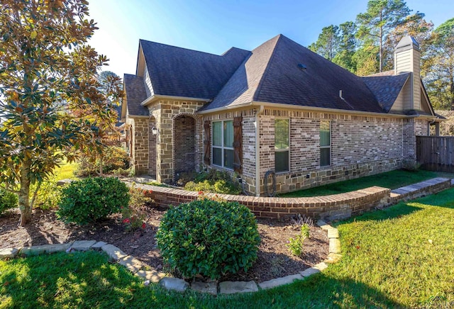 view of property exterior featuring a lawn