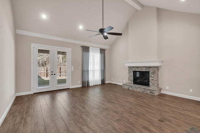 unfurnished living room featuring a fireplace, ceiling fan, french doors, and lofted ceiling with beams