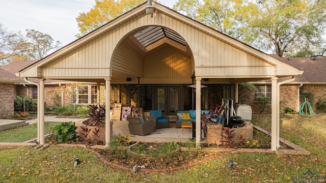 back of property with an outdoor living space, a yard, and a patio