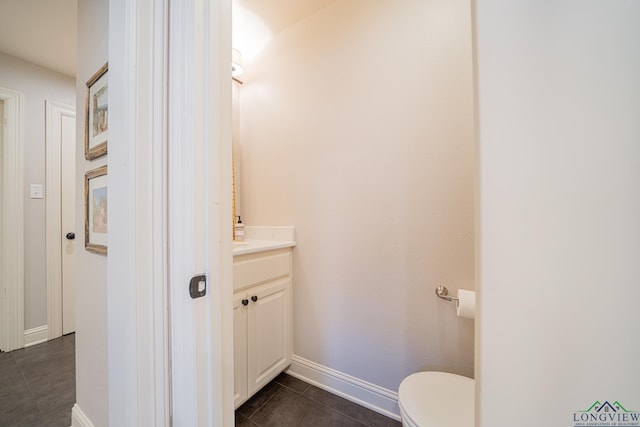 bathroom with tile patterned flooring, vanity, and toilet