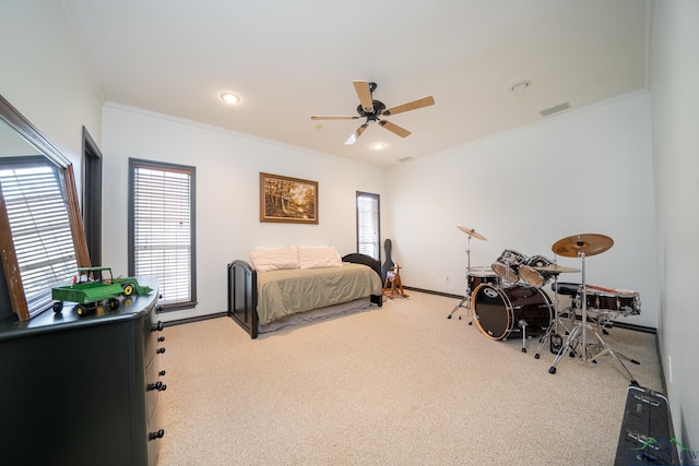 carpeted bedroom with ceiling fan and ornamental molding