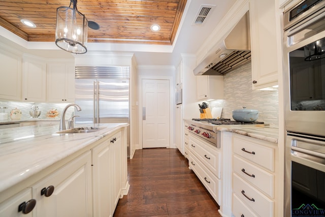 kitchen featuring sink, wall chimney exhaust hood, decorative backsplash, decorative light fixtures, and wood ceiling