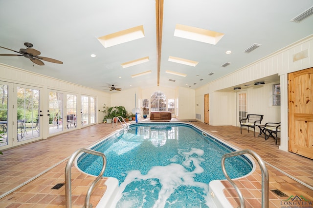 view of swimming pool featuring ceiling fan and a skylight