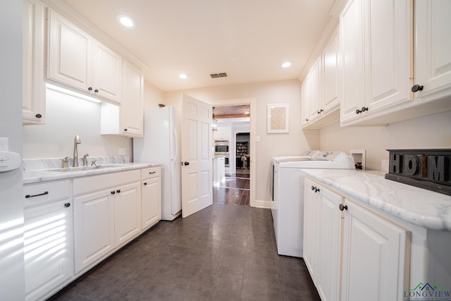 laundry area featuring separate washer and dryer and sink