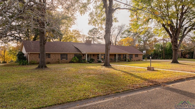 single story home featuring a front lawn