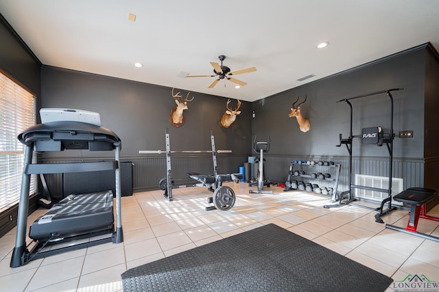 workout room with ceiling fan and light tile patterned flooring