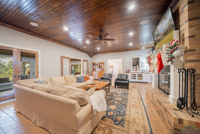 living room with plenty of natural light, ceiling fan, and wooden ceiling