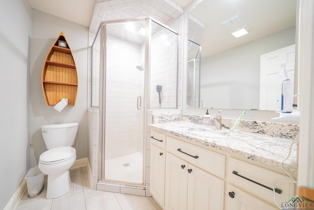 bathroom featuring toilet, vanity, tile patterned floors, and walk in shower