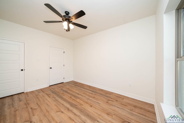 unfurnished bedroom with light wood-type flooring, ceiling fan, and a closet