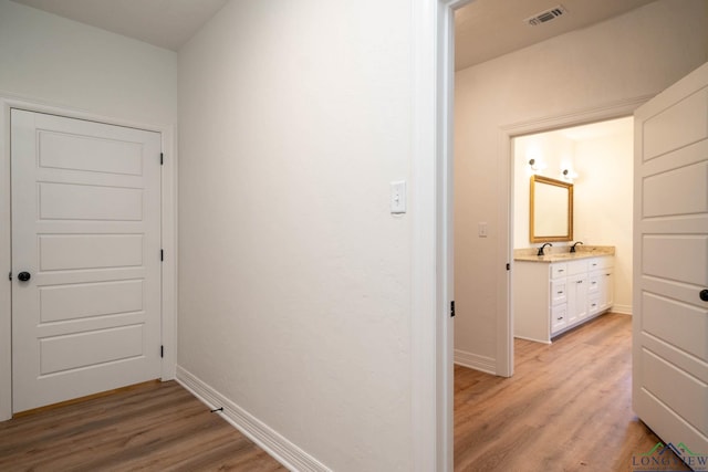 corridor with light wood-type flooring