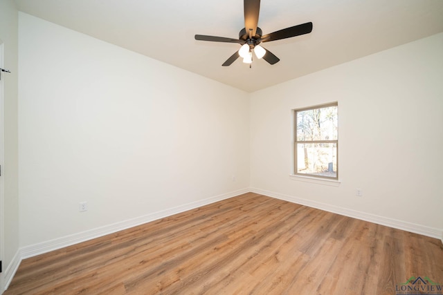 empty room with ceiling fan and light hardwood / wood-style flooring