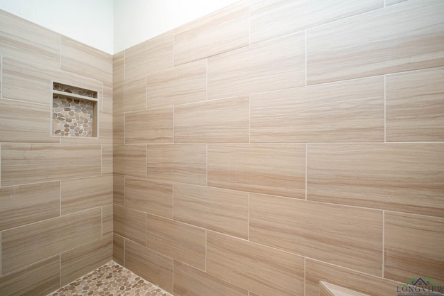 bathroom with tiled shower