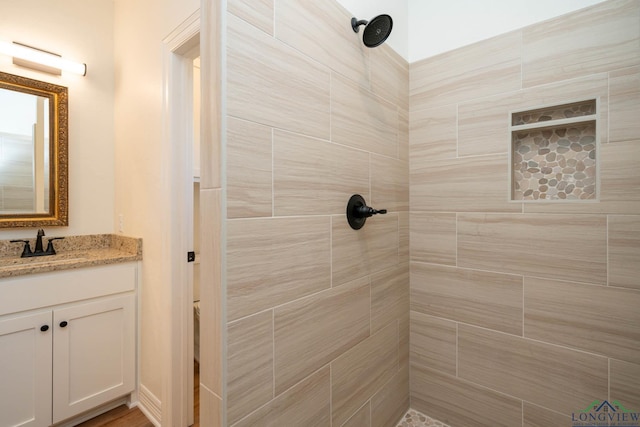 bathroom featuring vanity and a tile shower