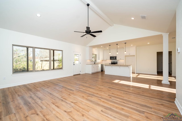 unfurnished living room featuring ornate columns, high vaulted ceiling, light hardwood / wood-style flooring, beam ceiling, and ceiling fan