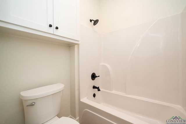 bathroom featuring toilet and bathing tub / shower combination