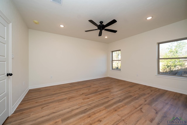 spare room with hardwood / wood-style flooring and ceiling fan