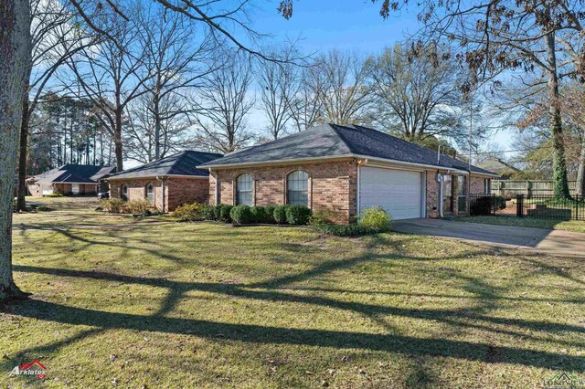 327 Forest Hls, Hallsville, TX 75650 - view of property exterior with driveway, a garage, and brick siding