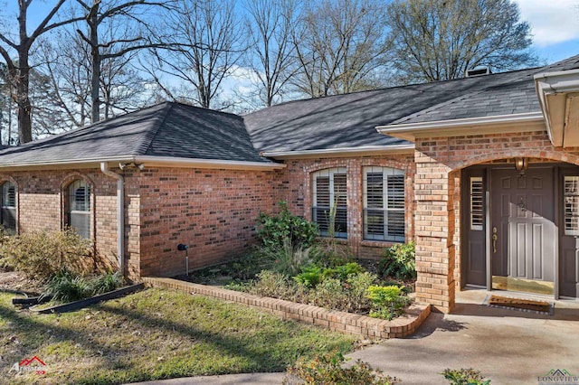 327 Forest Hls, Hallsville, TX 75650 - property entrance featuring brick siding and roof with shingles