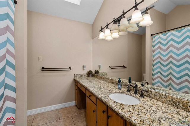 327 Forest Hls, Hallsville, TX 75650 - full bath featuring lofted ceiling, vanity, a skylight, a shower with shower curtain, and tile patterned floors