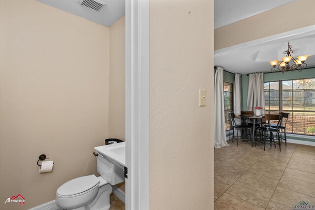 327 Forest Hls, Hallsville, TX 75650 - bathroom with a chandelier and tile patterned flooring