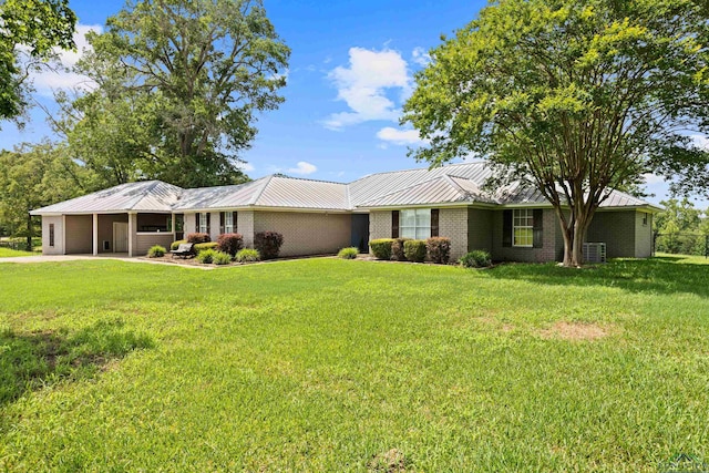 7356 Fm 49, Gilmer, TX 75644 - ranch-style house with a metal roof, a front lawn, brick siding, a standing seam roof, and a carport