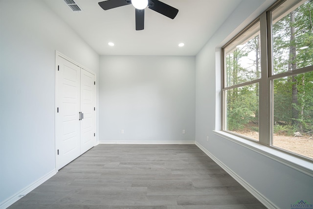 unfurnished bedroom featuring ceiling fan, a closet, and light hardwood / wood-style floors