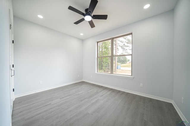 spare room with wood-type flooring and ceiling fan