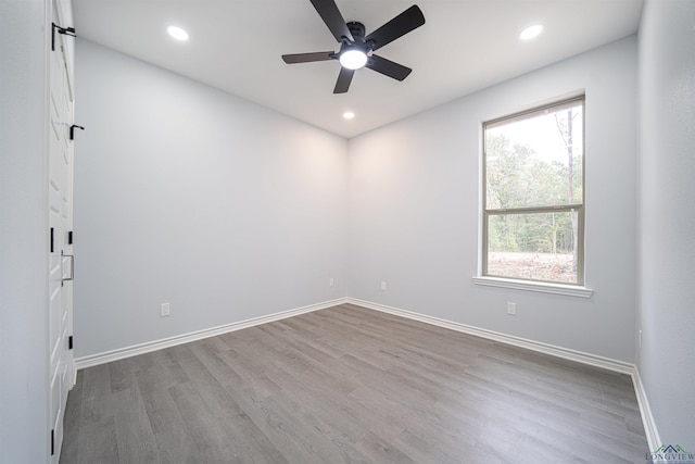 unfurnished room featuring ceiling fan, a wealth of natural light, and light hardwood / wood-style flooring