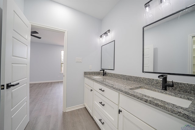 bathroom featuring hardwood / wood-style flooring, ceiling fan, and vanity