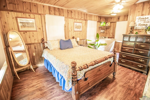 bedroom featuring wood walls, wood finished floors, washer and clothes dryer, and wooden ceiling