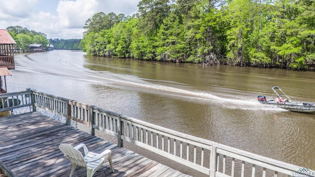 dock area featuring a forest view and a water view