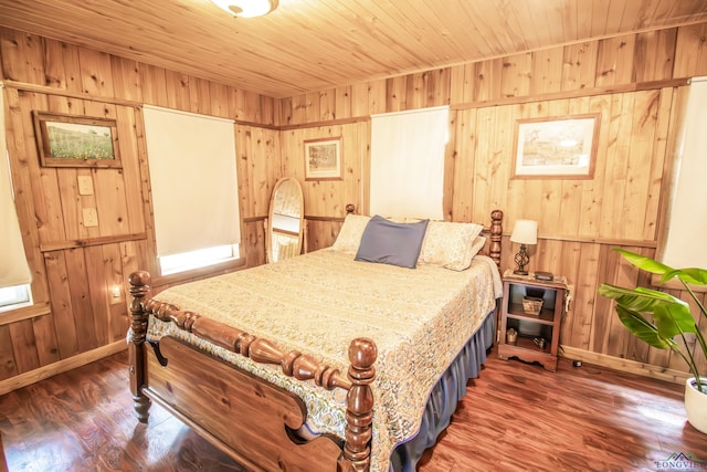 bedroom with baseboards, wood finished floors, wooden walls, and wood ceiling
