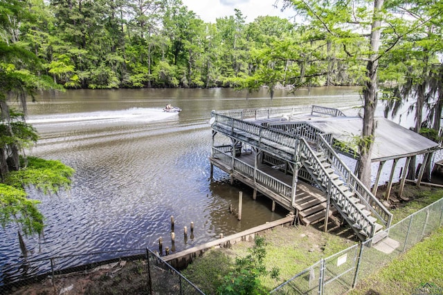 dock area featuring a water view and fence