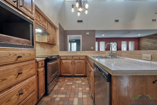 324 Highlander Hts, Hideaway, TX 75771 - kitchen with stainless steel appliances, a sink, under cabinet range hood, light countertops, and brick patterned flooring