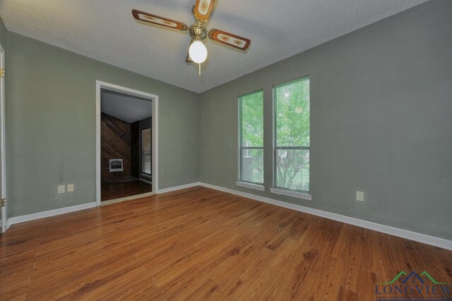 324 Highlander Hts, Hideaway, TX 75771 - spare room with a ceiling fan, wood finished floors, baseboards, a textured ceiling, and heating unit