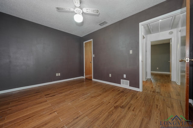 324 Highlander Hts, Hideaway, TX 75771 - unfurnished room with attic access, a textured ceiling, wood finished floors, ceiling fan, and baseboards