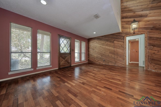 324 Highlander Hts, Hideaway, TX 75771 - entryway featuring wooden walls, wood finished floors, a textured ceiling, and baseboards