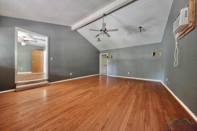 324 Highlander Hts, Hideaway, TX 75771 - spare room with a ceiling fan, wood finished floors, a wall unit AC, baseboards, and a textured ceiling