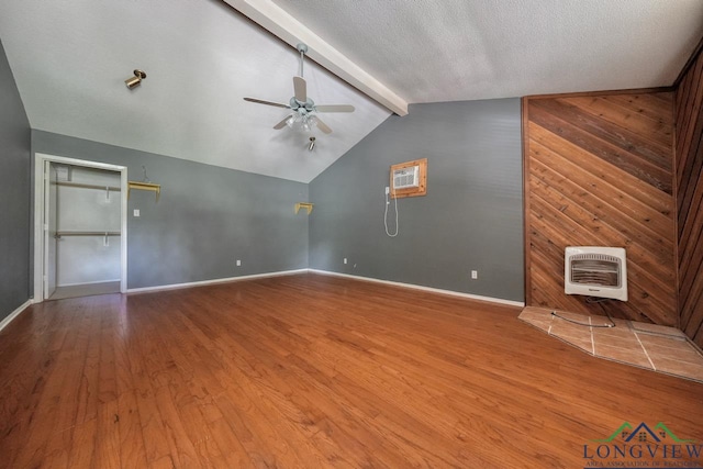324 Highlander Hts, Hideaway, TX 75771 - unfurnished living room featuring a ceiling fan, heating unit, wood finished floors, and baseboards