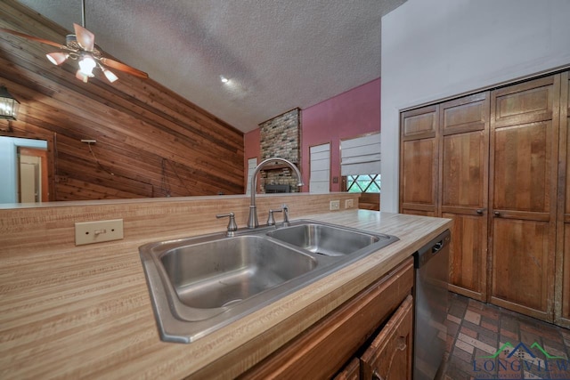 324 Highlander Hts, Hideaway, TX 75771 - kitchen featuring a sink, dishwasher, ceiling fan, a textured ceiling, and brick patterned flooring