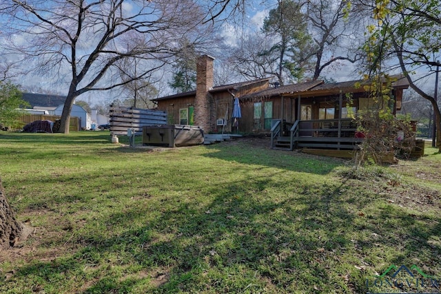 324 Highlander Hts, Hideaway, TX 75771 - rear view of house with a wooden deck, a hot tub, a lawn, and a chimney