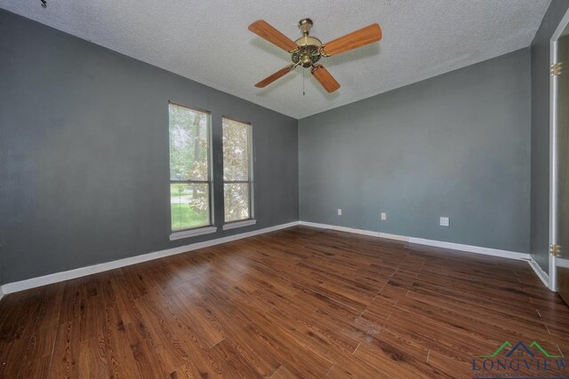 324 Highlander Hts, Hideaway, TX 75771 - spare room with dark wood-style flooring, a textured ceiling, a ceiling fan, and baseboards