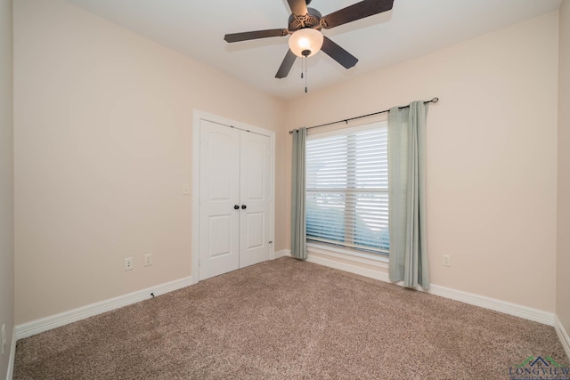 unfurnished bedroom with carpet floors, ceiling fan, and a closet